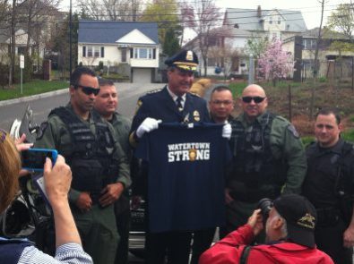 Watertown Police Chief Edward Deveau holds up a Watertown Strong T-shirt soon after the capture of the bombing suspect.