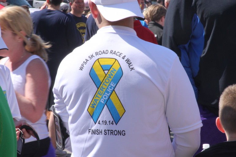 A man wears the Finish Strong Road Race. Proceeds from the race went to local charities including the One Fund and the Watertown Police Foundation, which helps community programs in town.