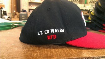 Watetown High School's baseball team is wearing hats with Lt. Ed Walsh's name embroidered on them.