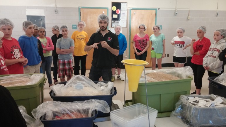 Marc Vermouth, New England Program Manager for Stop Hunger Now, tells volunteers about how the meals they are packing will help hungry children in Panama.
