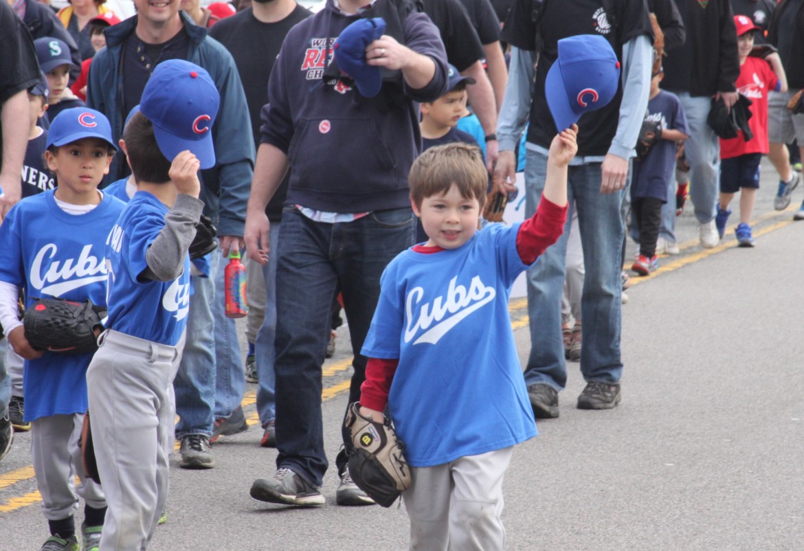 Young Watertown Baseball players march toward Casey Field for opening day. 