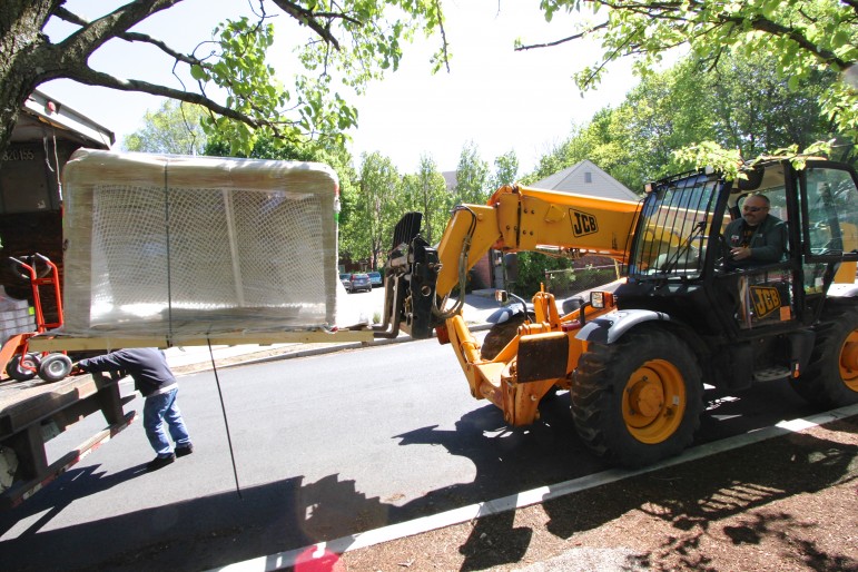 A forklift grabs the hockey goals that will go on the new street/ice hockey rink at Casey Park.
