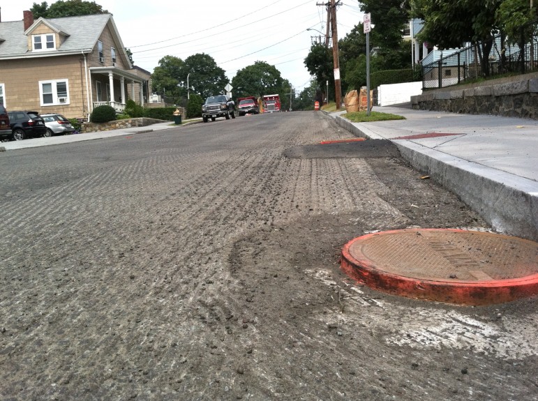 A road after being milled and prepared for overlay of new asphalt. 