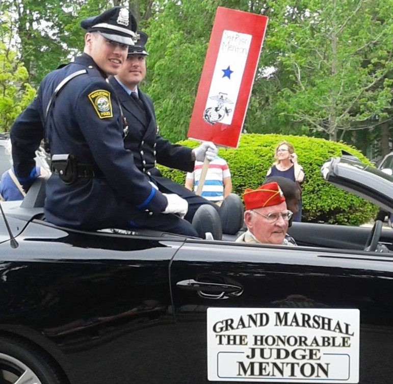 Grand Marshalls and brothers Police Officer Timothy Menton, left, and Firefighter Patrick Menton. Patrick is holding a sign honoring Ryan Menton, another grandson, who is serving in Okinawa with the Marines.