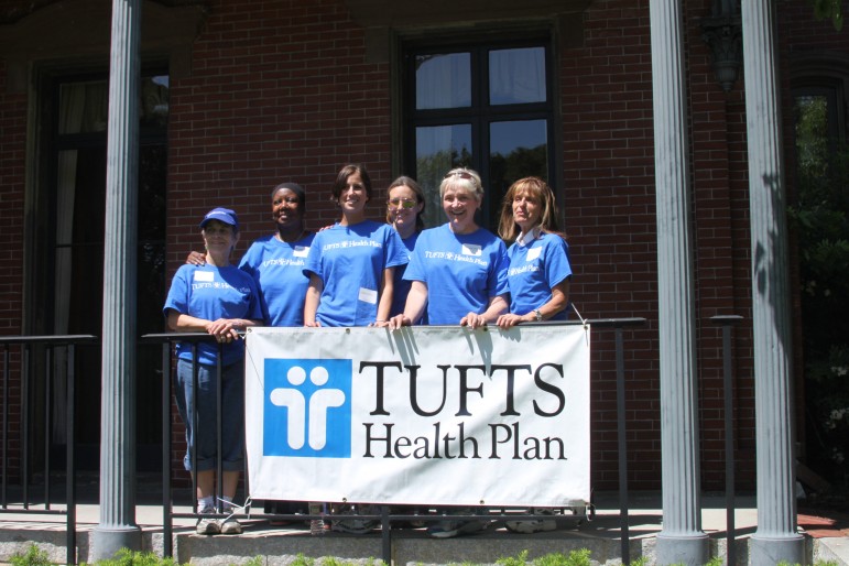 Several Tufts Health Plan employees spend the day at the Commander's Mansion planting flowers and plants.