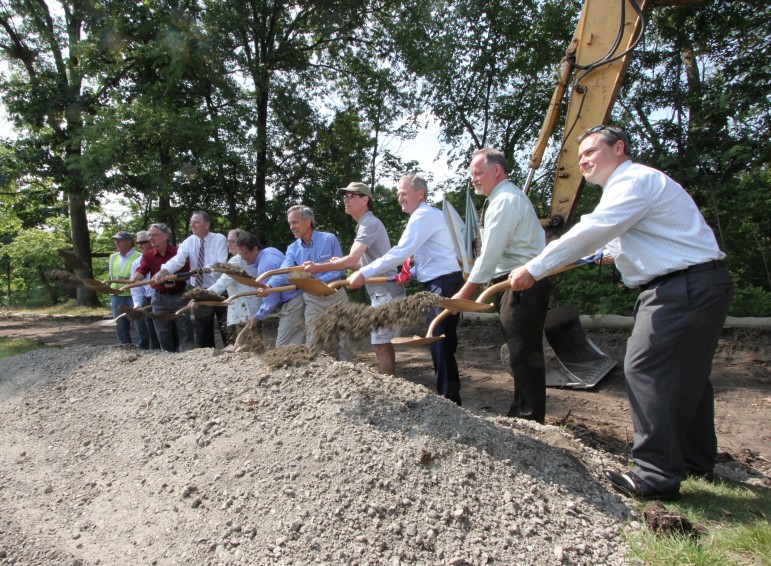 State officials, local legislators, town officials and others involved in the Watertown Riverfront Park improvements break ground on the project on July 21. 