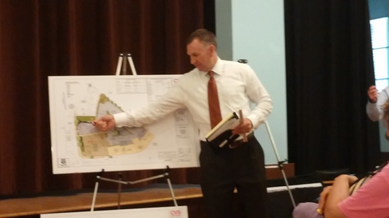 Project Manager of points to a plan for the new CVS in Coolidge Square.
