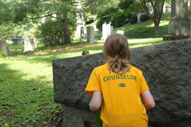 A camper from the Vacation Garden School spotted a chipmunk on one of the grave stones at Mount Auburn Cemetery.