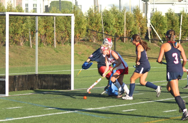 Watertown's Rachel Campbell stick hands around the Lincoln-Sudbury goalie for a second half goal.