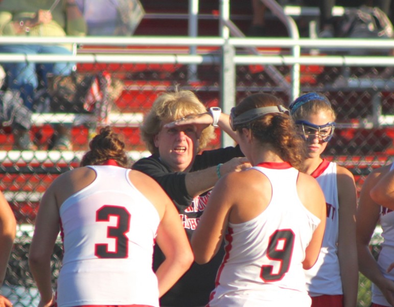 Watertown field hockey coach Eileen Donahue talks to her team at halftime.