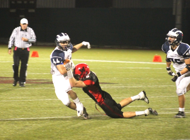 Watertown's Brian Dallacosta tackles Swampscott running back Michael Faia.