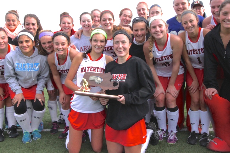 Watertown field hockey co-captains Allie Doggett, left, and Emily Loprete hold the North Section Div. 2 Championship trophy after the Raiders beat Weston 2-0.