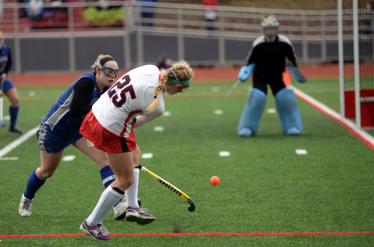 Watertown's Rachel Campbell scored the first goal in the Raiders' 5-0 state final victory. Here she gets off a shot on goal while being defended by Auburn's Carly Zona