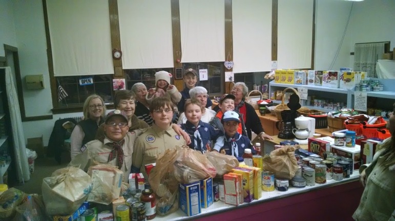 St. Vincent de Paul’s Food Pantry Volunteers from the Boy Scouts (left to right): Jonathan Fujiwara, Daniel VanRyn, Ben VanRyn, Edward Hammonds, Jayne Popiel, Ellen Dupuis, Maureen Henry, Mary Fujiwara, Peggy Little (Food Pantry Coordinator), James Munroe-Ellis, and Dorothy Brown.