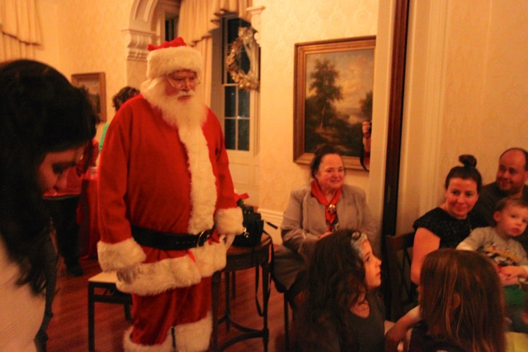 Santa Claus visited children at the Commander's Mansion Holiday Open House.
