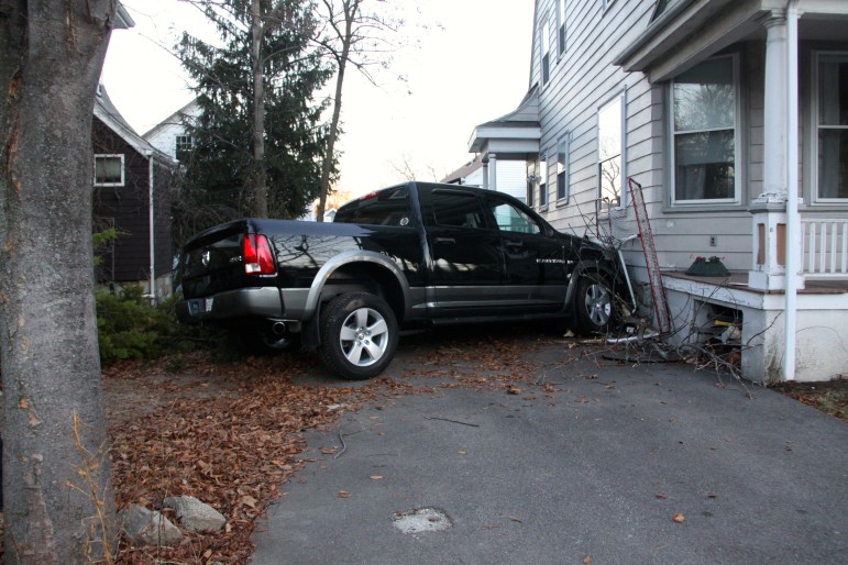 A pickup truck struck the side of a School Street home after the driver lost control.