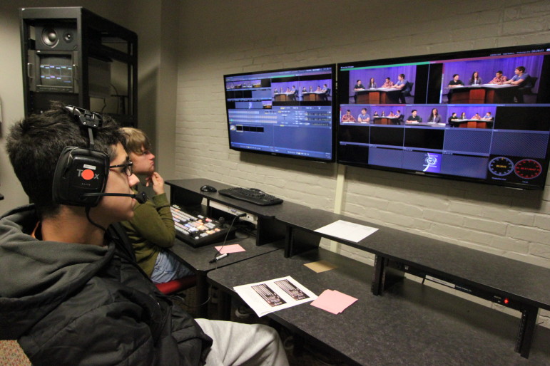 Two Watertown High School students sit at the control room at the Watertown Cable studio.