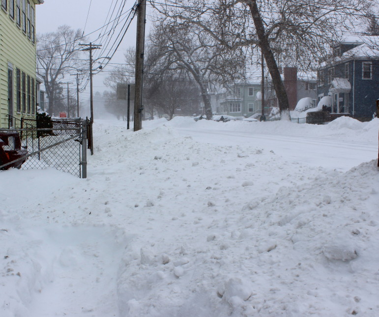 Snow piled up on Main Street looking east Tuesday afternoon.