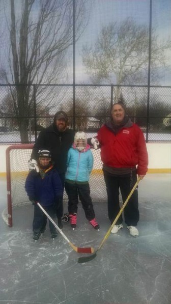 Recreation Director Peter Centola, right, with some of the residents who came out for the opening of Casey Rink - Watertown's outdoor skating facility.