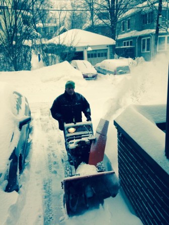 Ken Davis gets started removing snow with a snowblower.
