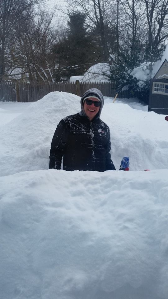 A father and his 4-year-old son (that's his little hand waving) dig out after the Feb.  15 blizzard.  