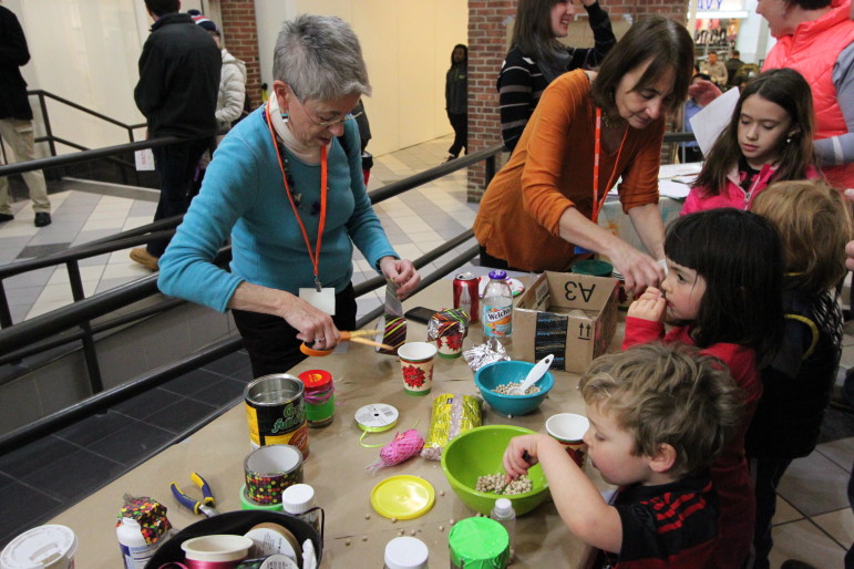 Kids made noise makers by putting dried beans in plastic cups.