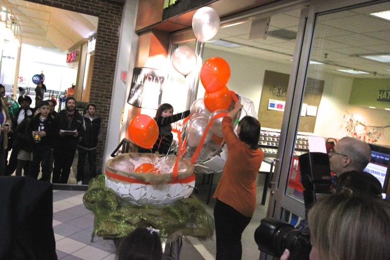 Balloons float out of a giant paper mache egg at the grand opening of HATCH at the Arsenal Project.