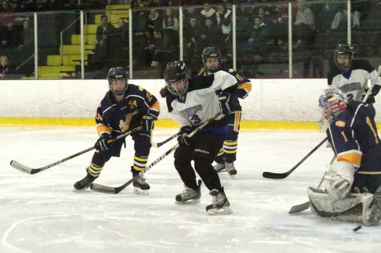 Watertown/Belmont’s Erin McLaughlin redirects the puck past Andover goalie Meaghan Johnson for the Mauraiders’ first goal.