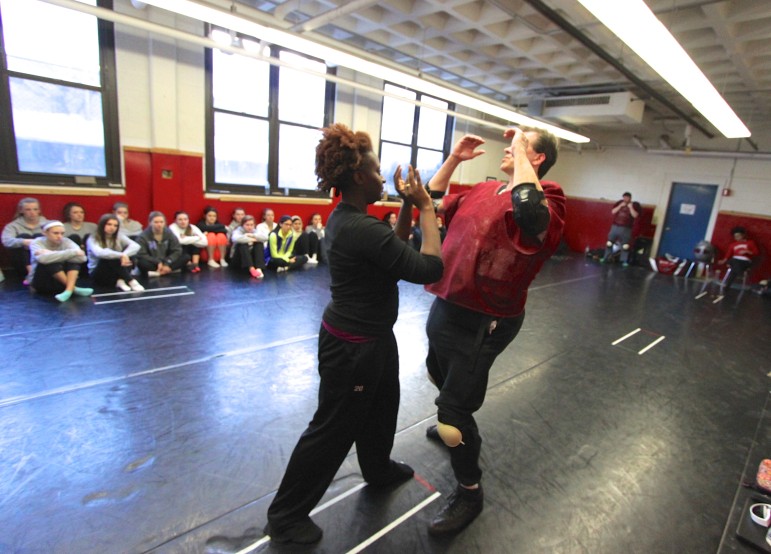 Self-defense instructors from IMPACT Boston show how to knee an attacker in the groin.