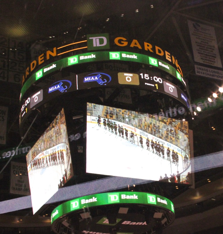 The TD Garden scoreboard shows the Watertown boys' hockey team lining up for the National Anthem.