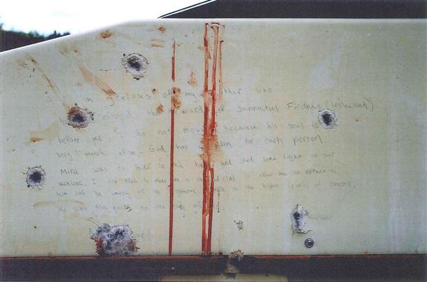 An evidence photo of the note prosecutors say Marathon Bombing suspect Dzhokhar Tsarnaev wrote inside the Watertown boat. The red streaks are Tsarnaev's blood.
