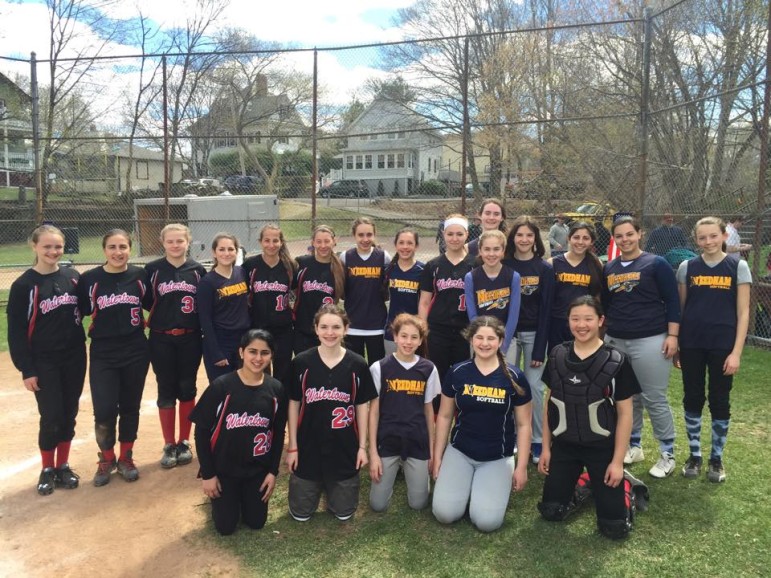 Players from the Watertown 14U and Needham 14U softball teams pose before their game on opening day.