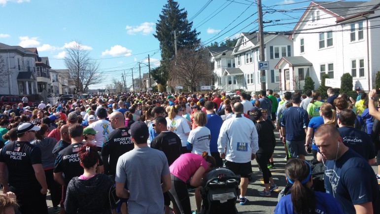 Runners and walkers line up on Arlington Street for the Watertown Finish Strong race on Sunday. 