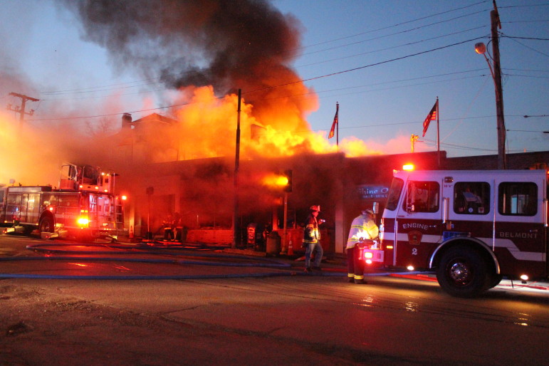Flames engulf a block of businesses in Belmont, just across the town line on Saturday evening.