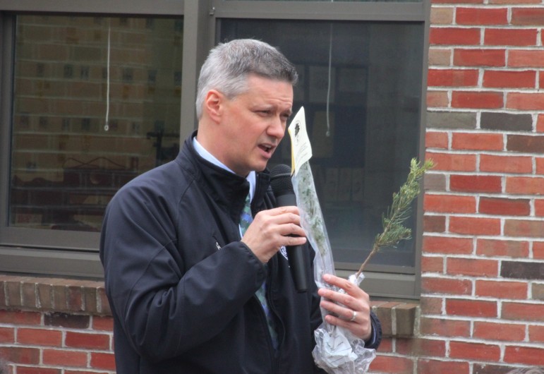 Watertown Tree Warden Chris Hayward shows the Cunniff students one of the saplings he gave to them to take home.