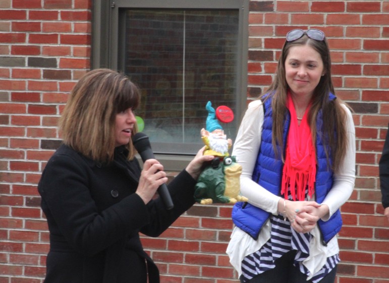 Cunniff fourth-grade teacher Barbara Barry and Cunniff parent Joy Lamberton Arcolano present the school's new gnome, Phillipe and his frog Fred, to the students. 