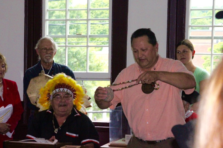 Henry Bear, right, prepares to give a medallion to Roland Jerome, left. Bear is the descendent of one of the signers of the Treaty of Watertown.