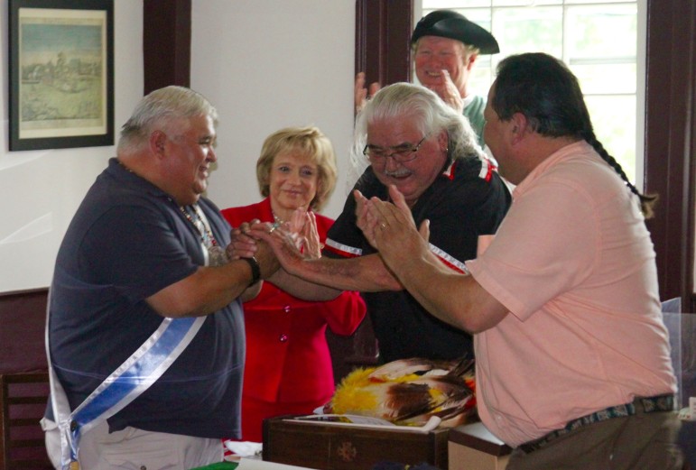 Roland Jerome, center, shakes the hand of Ron Knockwood after Jerome passed the role of the "chief" of the Mi'kmaq Indians during the reenactment of the Treaty of Watertown.