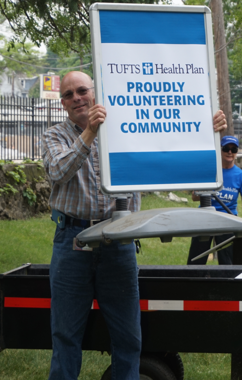 A Tufts Health Plan employee shows his volunteering spirit during the seventh annual Corporate Volunteer Day.