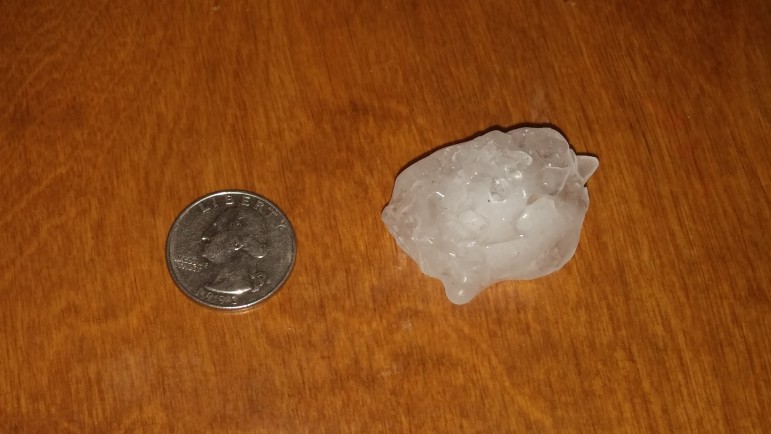 One of the larger hail stones from the Aug. 4 storm next to a quarter.
