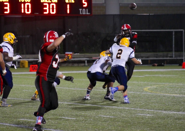 Watertown quarterback Deon Smith threw a screen pass to running back Zach Rimsa against Arlington Catholic.