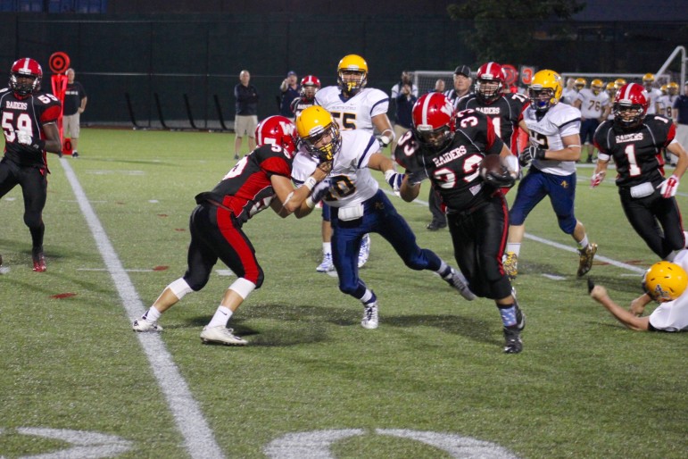 A block by Watertown's Steve Mey helped running back Zach Rimsa gain big yards in the 38-35 win over Arlington Catholic.