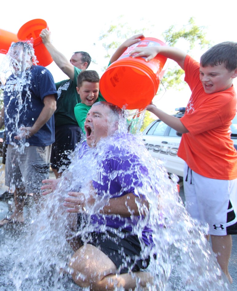 Watertown Police Sgt. Tom Grady's sons got the honor of dumping the bucket on him. 