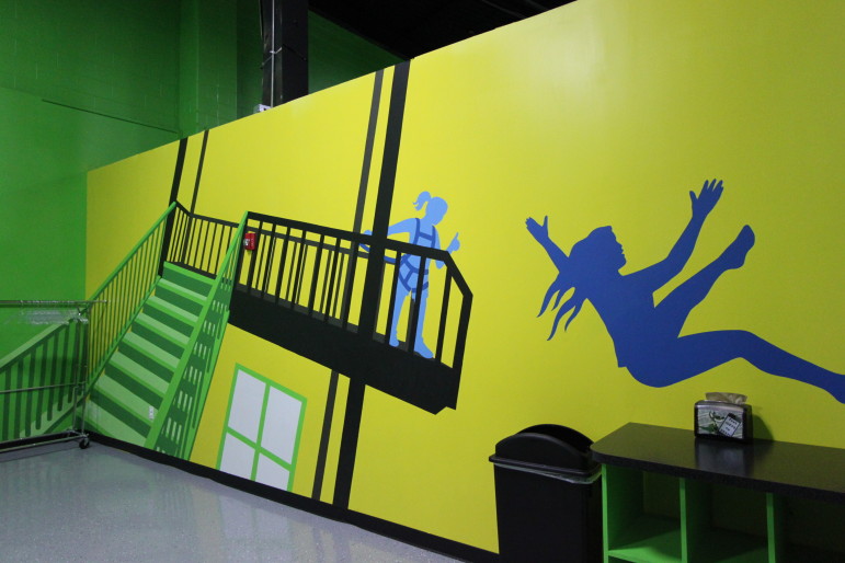 The mural at Launch Watertown depicts the tower and stunt bag. The mural was painted by Watertown's Kim Foley.