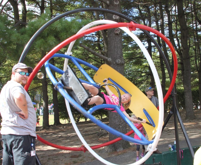 A girl takes a whirl on a ride at the Faire on the Square. 