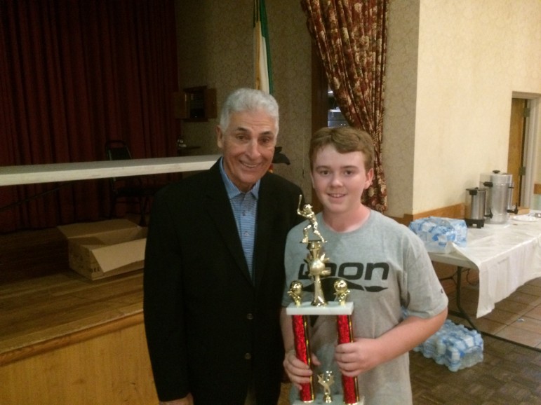 Tim McCall, the Watertown Youth Baseball Sportsperson of the year holds his trophy, which was presented to him by Dick Berardino.