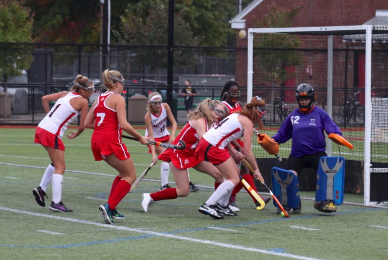 Watertown senior Ally McCall, No. 4, passes to teammate Grace Duguay who scored one of her two goals in the 6-0 win over Melrose for the record streak clincher.