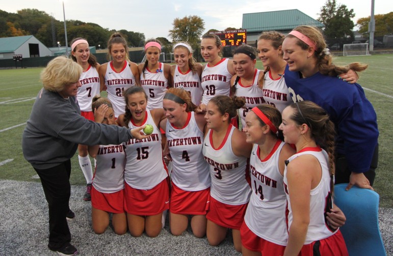 Head Coach Eileen Donahue presents the Watertown field hockey team with the ball they used to set the new national unbeaten streak record of 154 straight games.