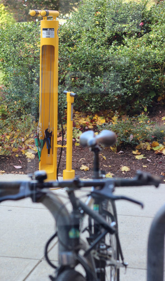The new bicycle repair station is in front of the library near the bike racks.