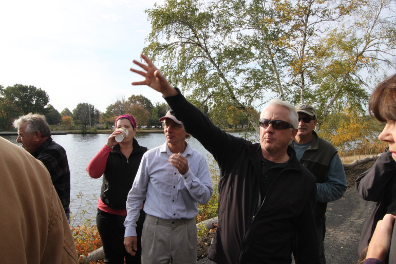 The DCR's Dan Driscoll shows a group of residents - including State Rep. Jonathan Hecht, at his left -around the construction of the new bicycle and pedestrian path along the Charles River on Greenough Boulevard.